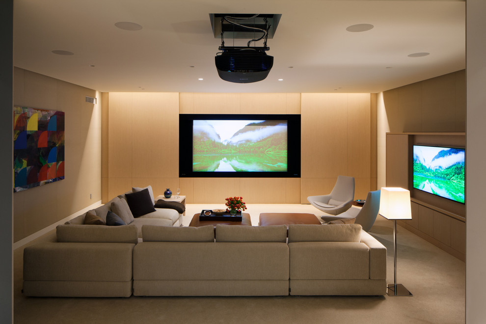 This is an example of a contemporary home theatre in Los Angeles with a projector screen.