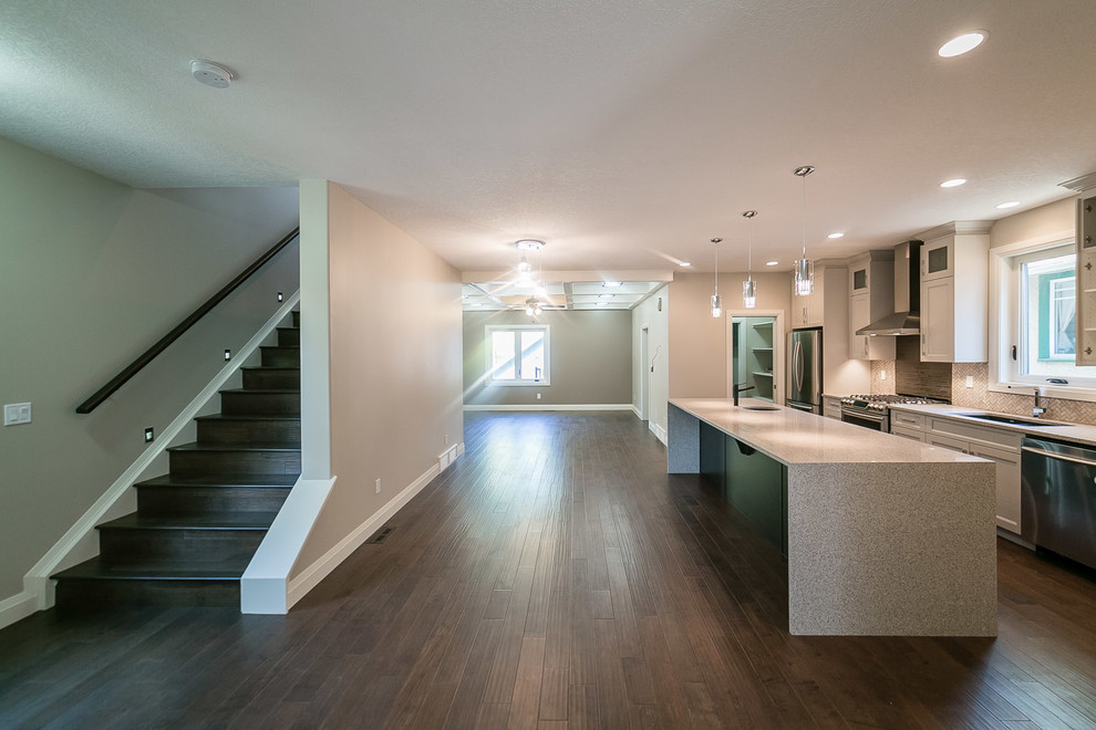 Kitchen pantry - mid-sized transitional galley dark wood floor kitchen pantry idea in Edmonton with shaker cabinets, white cabinets, multicolored backsplash, matchstick tile backsplash, stainless steel appliances, an island, an undermount sink and granite countertops