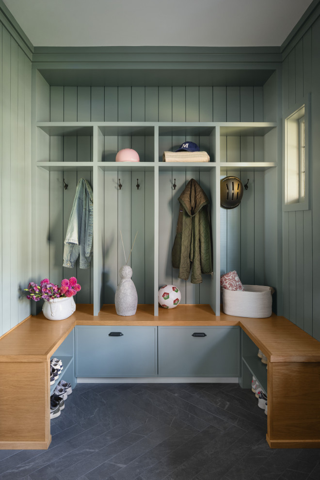 Transitional black floor and shiplap wall mudroom photo in New York with blue walls