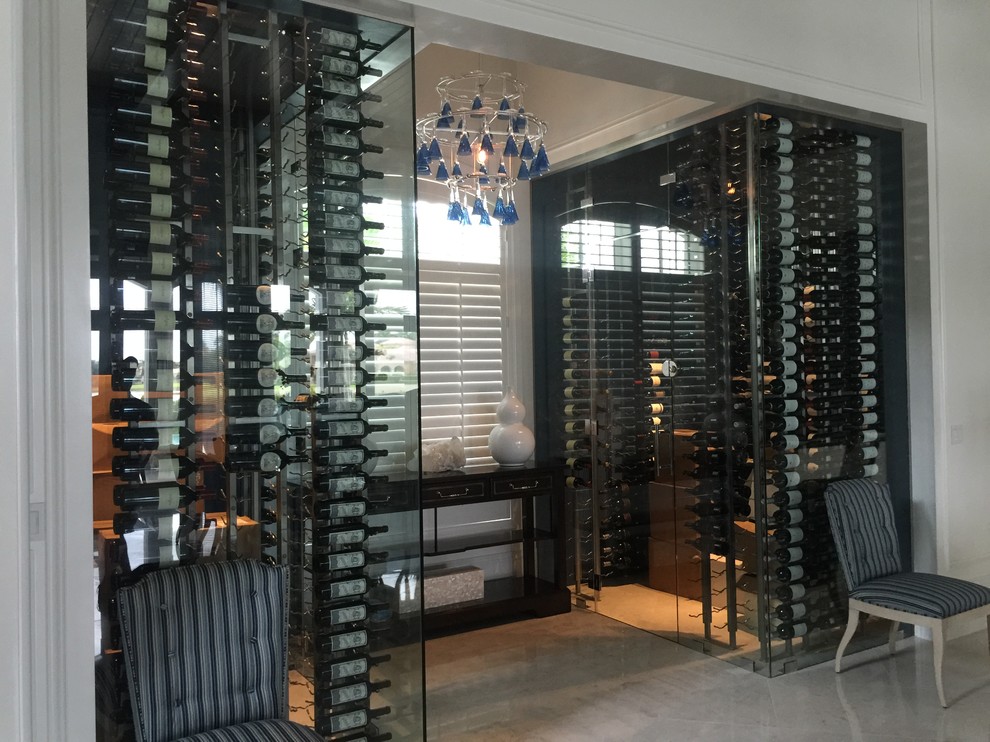 This is an example of a large transitional wine cellar in Miami with marble floors and storage racks.