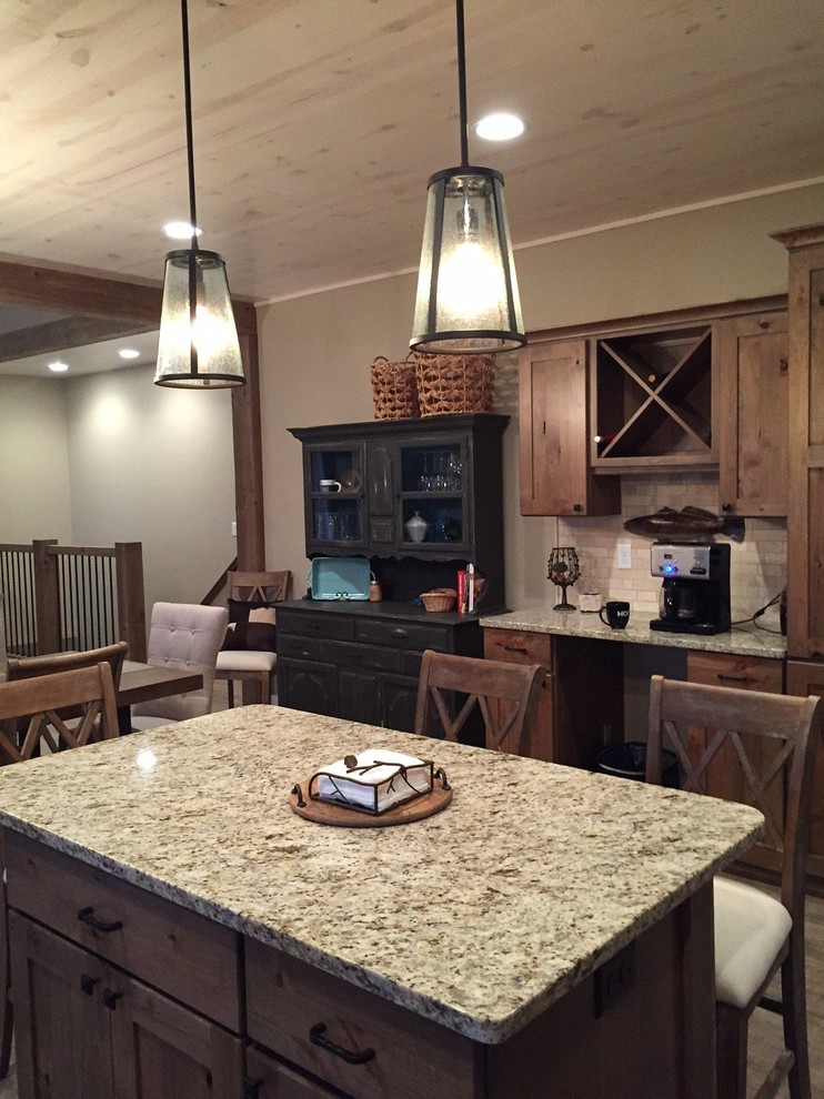 Open concept kitchen - mid-sized rustic l-shaped open concept kitchen idea with an undermount sink, beige backsplash, an island, shaker cabinets, medium tone wood cabinets, granite countertops and gray countertops