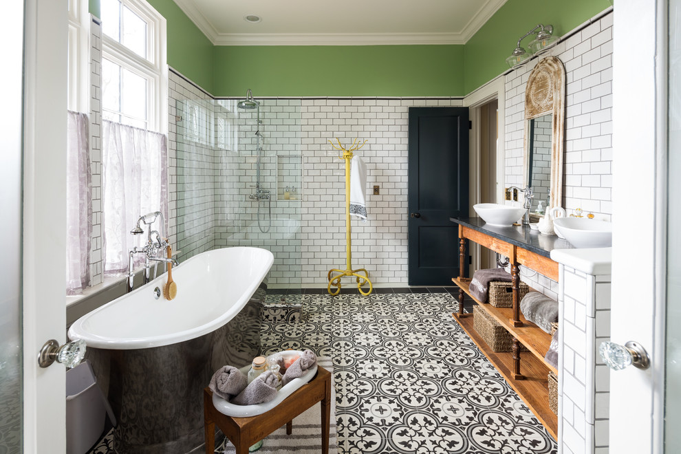 Inspiration for a country master bathroom in Atlanta with medium wood cabinets, a freestanding tub, a curbless shower, white tile, subway tile, grey walls, cement tiles, a vessel sink, multi-coloured floor, an open shower, black benchtops and open cabinets.