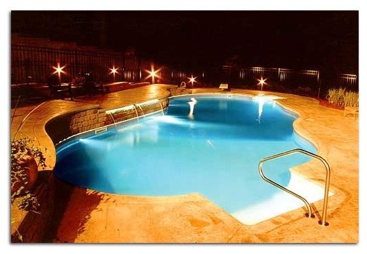 Inspiration for a backyard stone and custom-shaped pool remodel