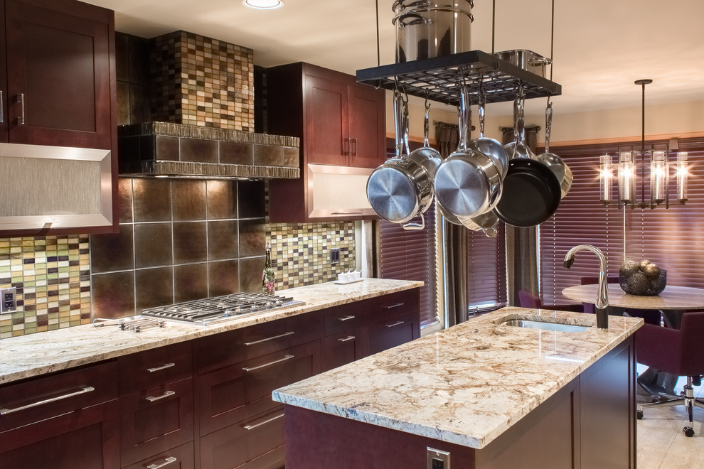 Example of a trendy ceramic tile kitchen design with a double-bowl sink, shaker cabinets, dark wood cabinets, granite countertops, multicolored backsplash, glass tile backsplash, paneled appliances and an island