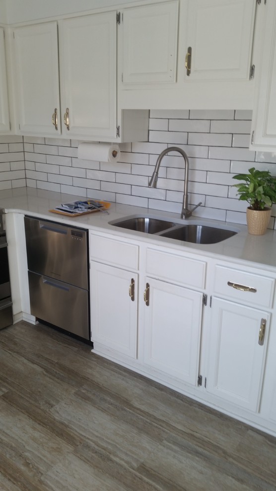 Inspiration for a small transitional l-shaped vinyl floor and beige floor eat-in kitchen remodel in Columbus with an undermount sink, recessed-panel cabinets, white cabinets, quartzite countertops, white backsplash, subway tile backsplash, stainless steel appliances and white countertops