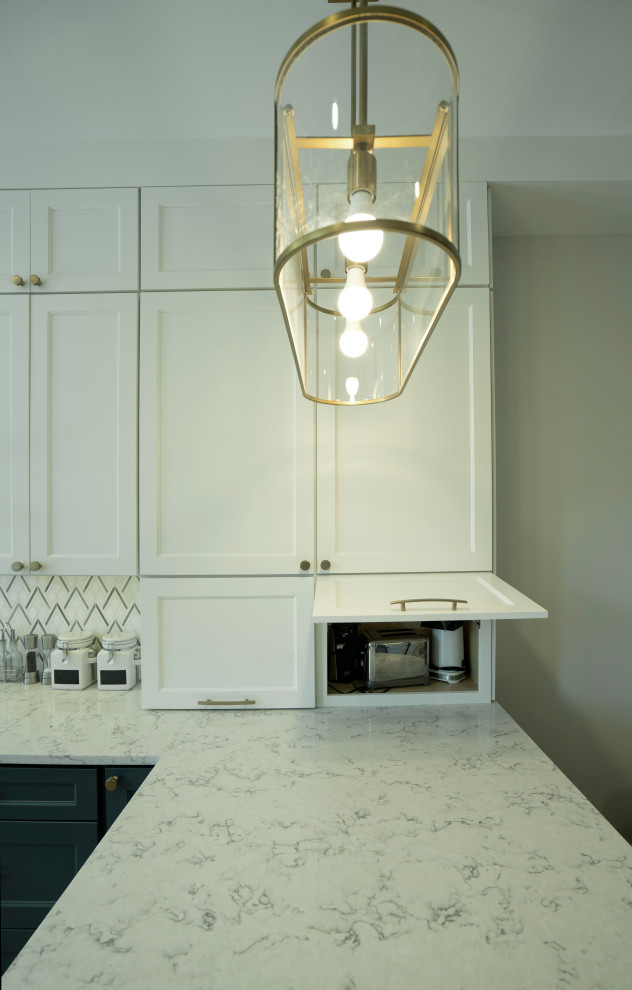 This is an example of a modern kitchen in DC Metro with recessed-panel cabinets, white cabinets, quartz benchtops, white splashback, ceramic splashback, medium hardwood floors, a peninsula and white benchtop.