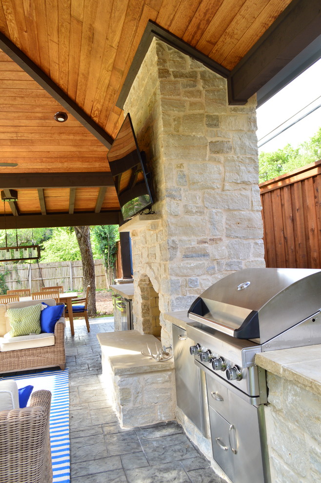 Inspiration for an expansive transitional backyard patio in Dallas with with fireplace.