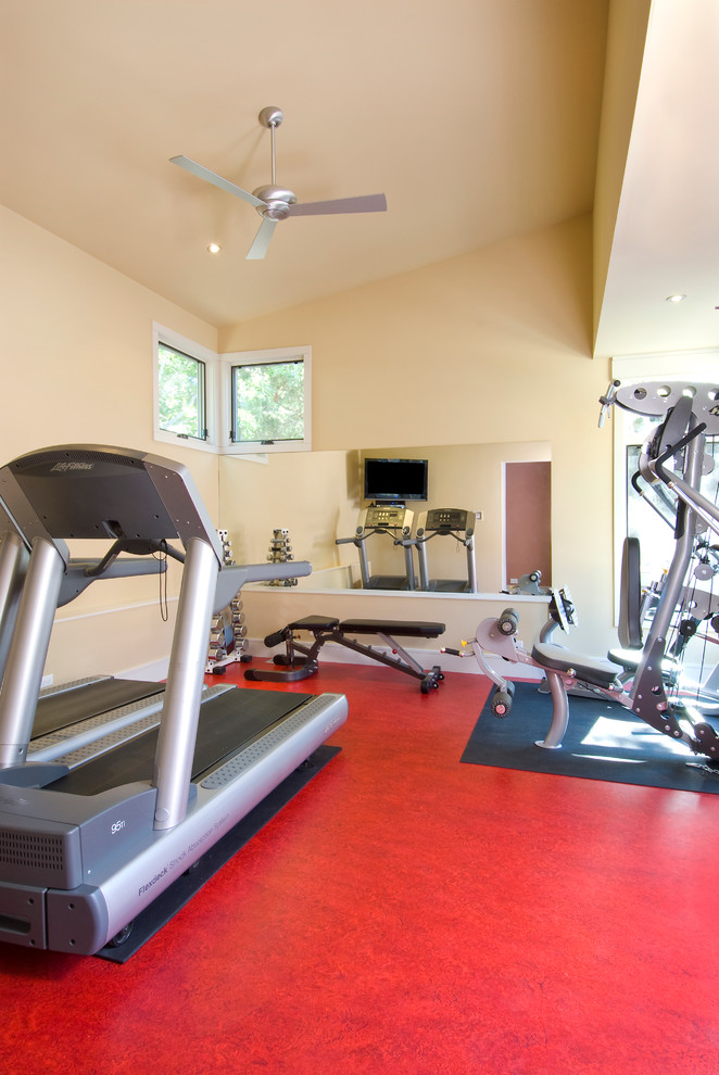 Photo of a modern home gym in Portland with red floor.