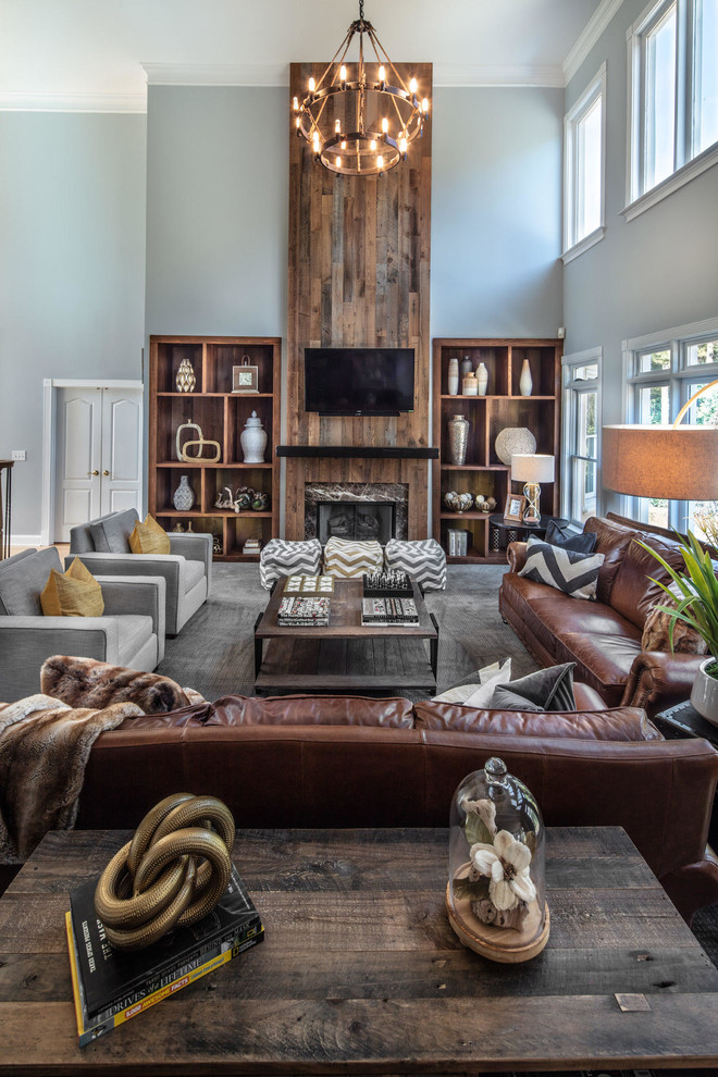 Photo of a large country open concept family room in Atlanta with grey walls, carpet, a standard fireplace, a built-in media wall, grey floor, wood walls and a stone fireplace surround.