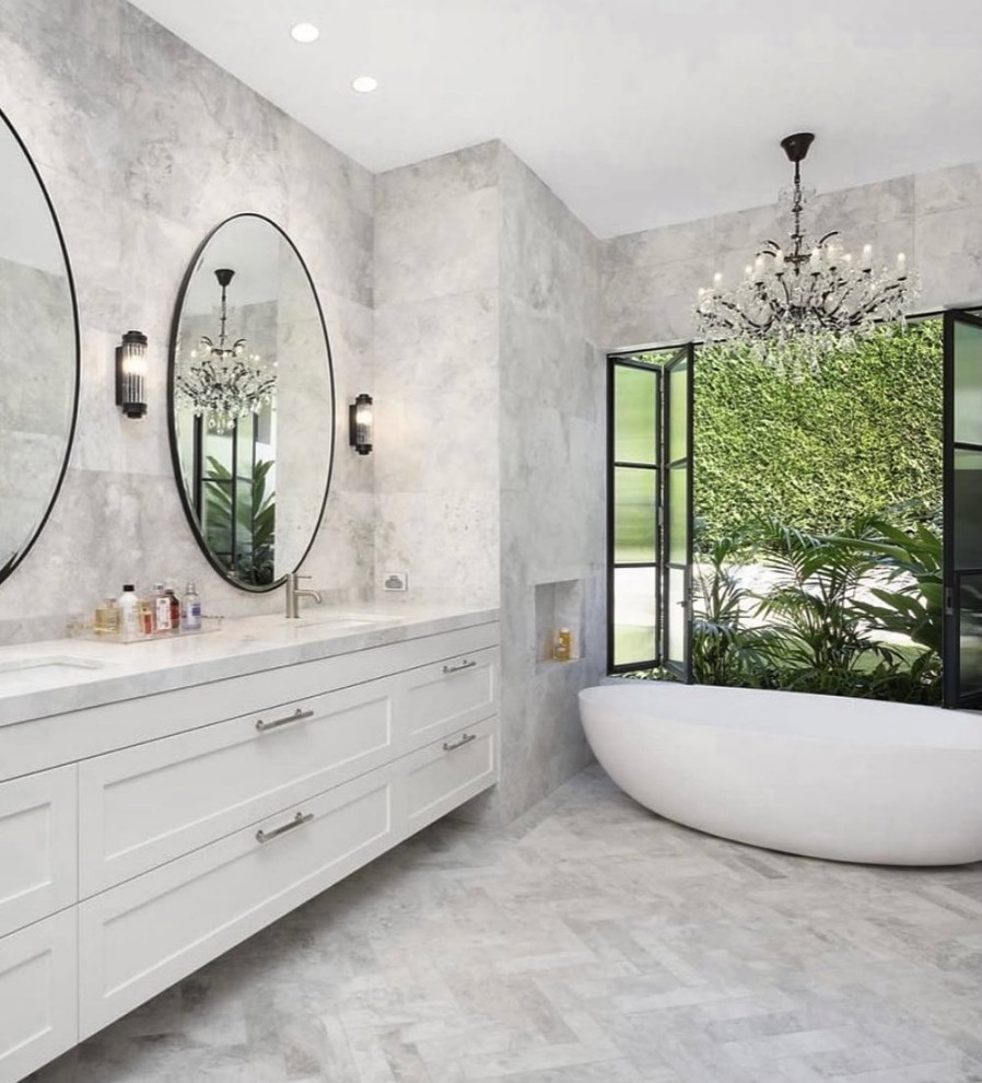 This is an example of a large contemporary master bathroom in Sydney with shaker cabinets, white cabinets, a freestanding tub, a drop-in sink, a double vanity and a floating vanity.