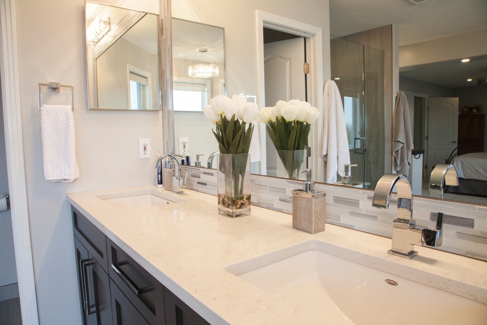 Inspiration for a large transitional master beige tile and glass sheet porcelain tile freestanding bathtub remodel in Edmonton with shaker cabinets, brown cabinets, a two-piece toilet, beige walls, an undermount sink and quartz countertops