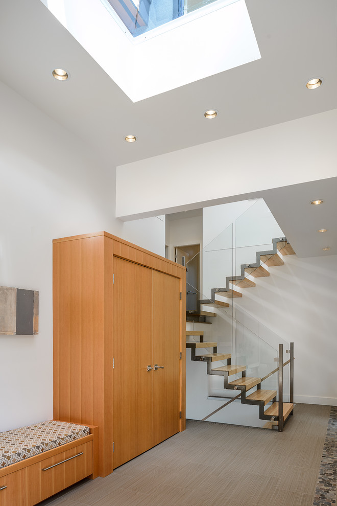 Photo of a contemporary wood u-shaped staircase in Vancouver with open risers.