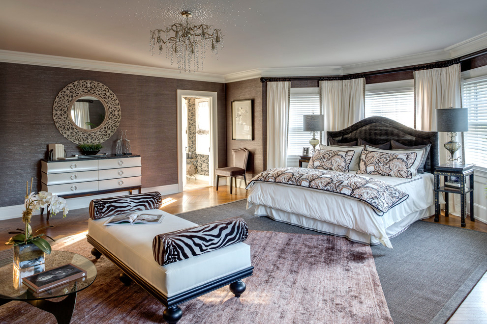 Photo of a transitional master bedroom in New York with brown walls and medium hardwood floors.