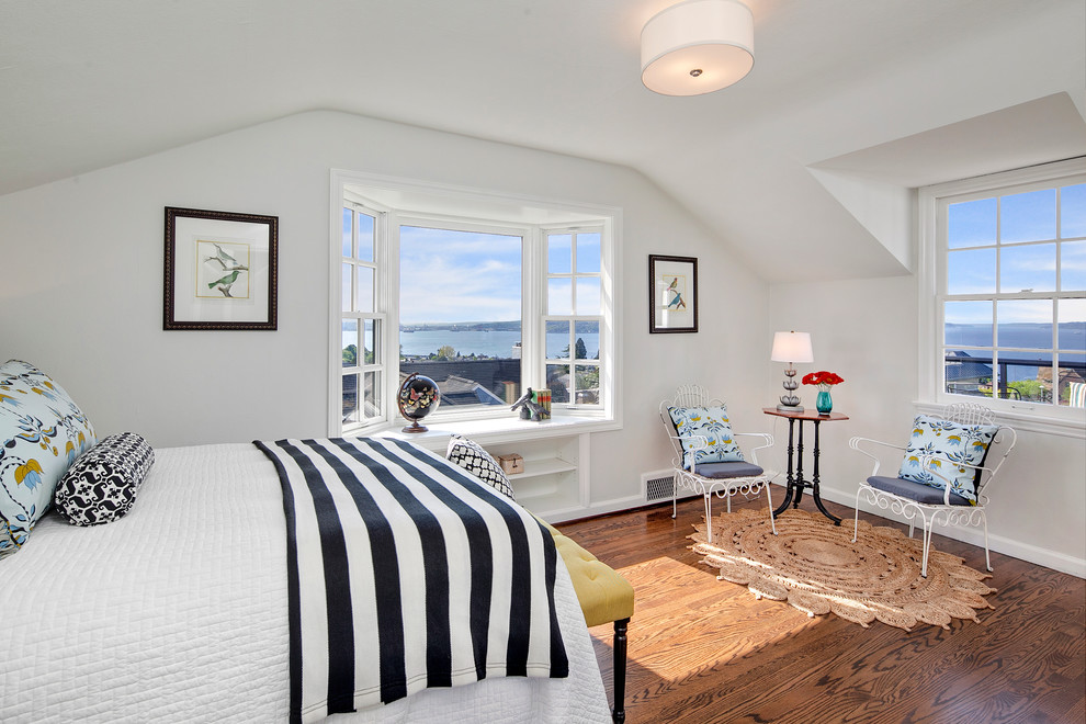 Photo of a large beach style guest bedroom in Seattle with white walls and dark hardwood floors.