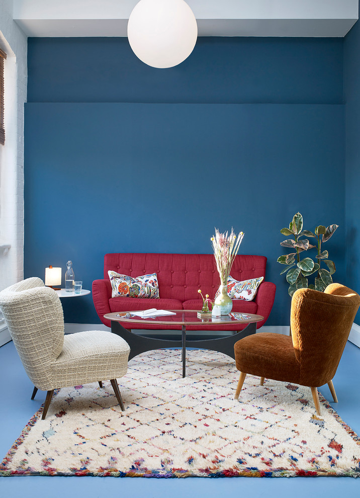 This is an example of a contemporary formal living room in London with blue walls and blue floor.