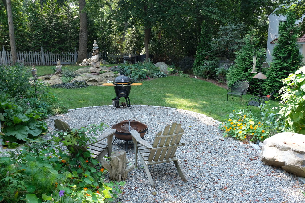 Photo of a small country backyard patio in Boston with a fire feature, gravel and no cover.