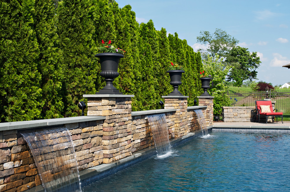 This is an example of a traditional rectangular pool in Philadelphia with a water feature.