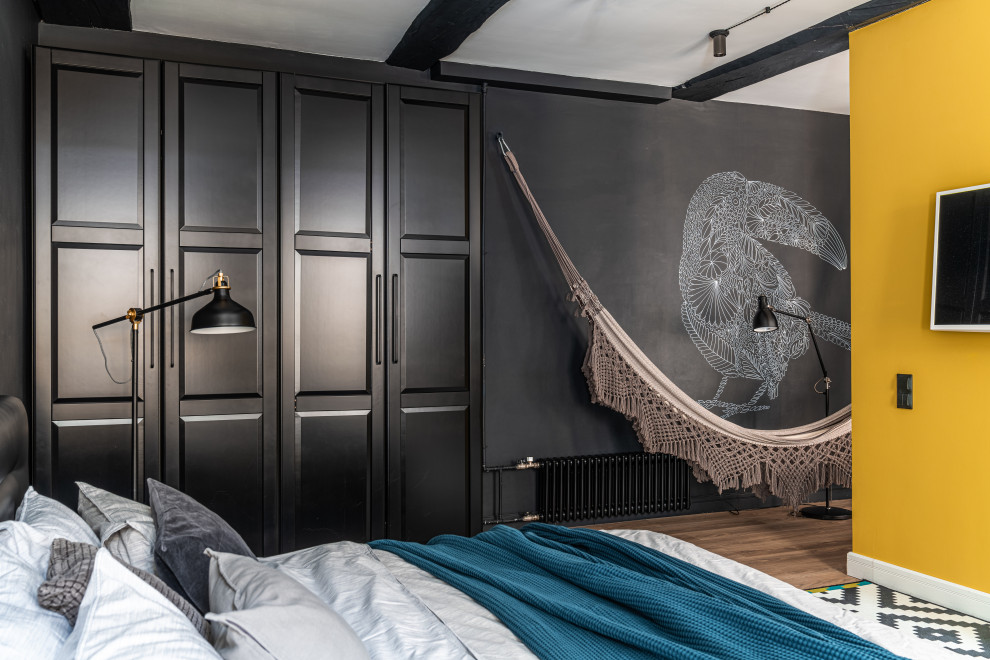 Inspiration for a medium sized scandinavian bedroom in Saint Petersburg with black walls, laminate floors, beige floors and exposed beams.
