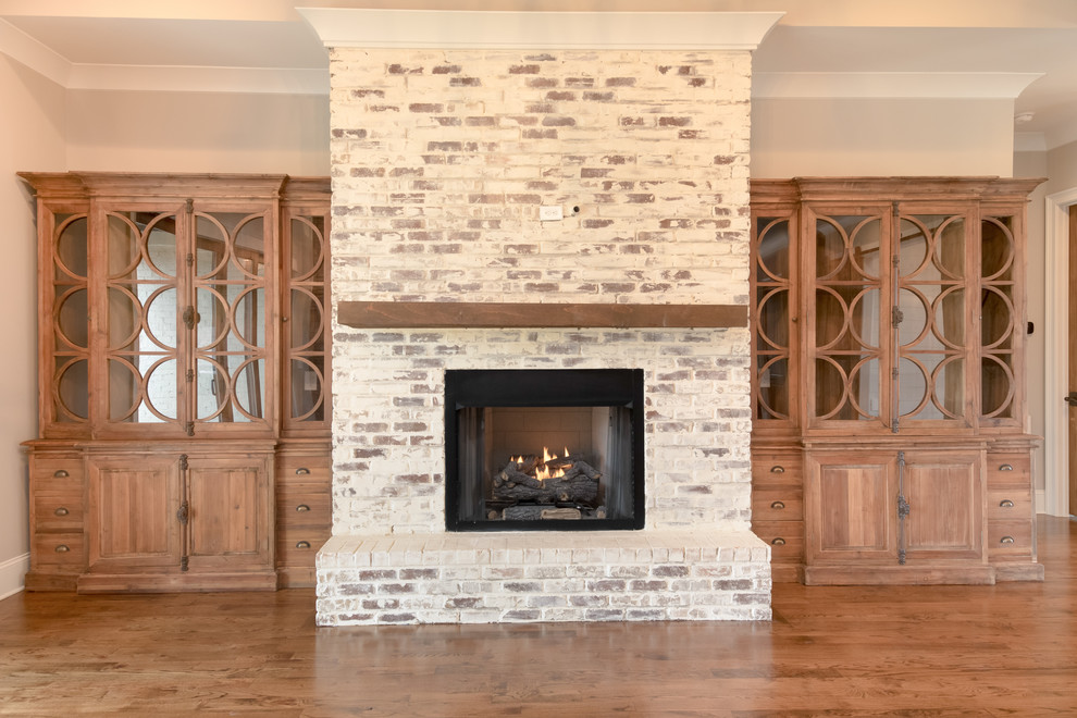 Living room - large craftsman open concept dark wood floor living room idea in Other with gray walls, a standard fireplace, a brick fireplace and no tv