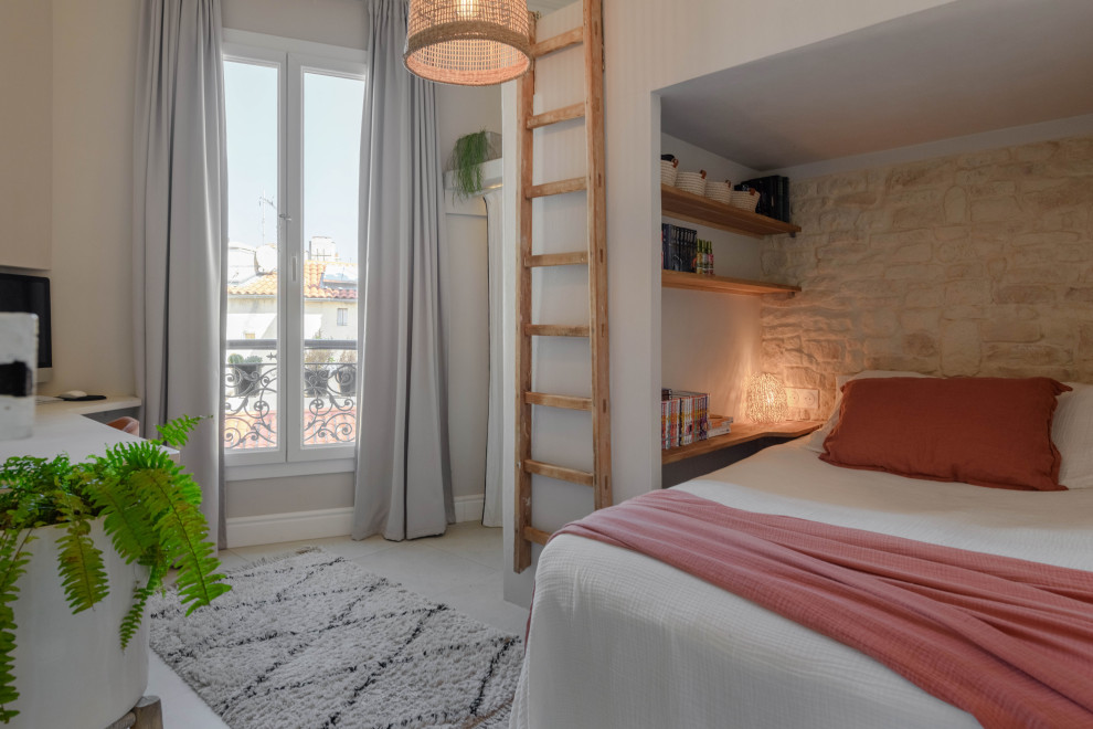 Photo of a small contemporary kids' room for girls in Marseille with beige walls, ceramic floors, beige floor and brick walls.