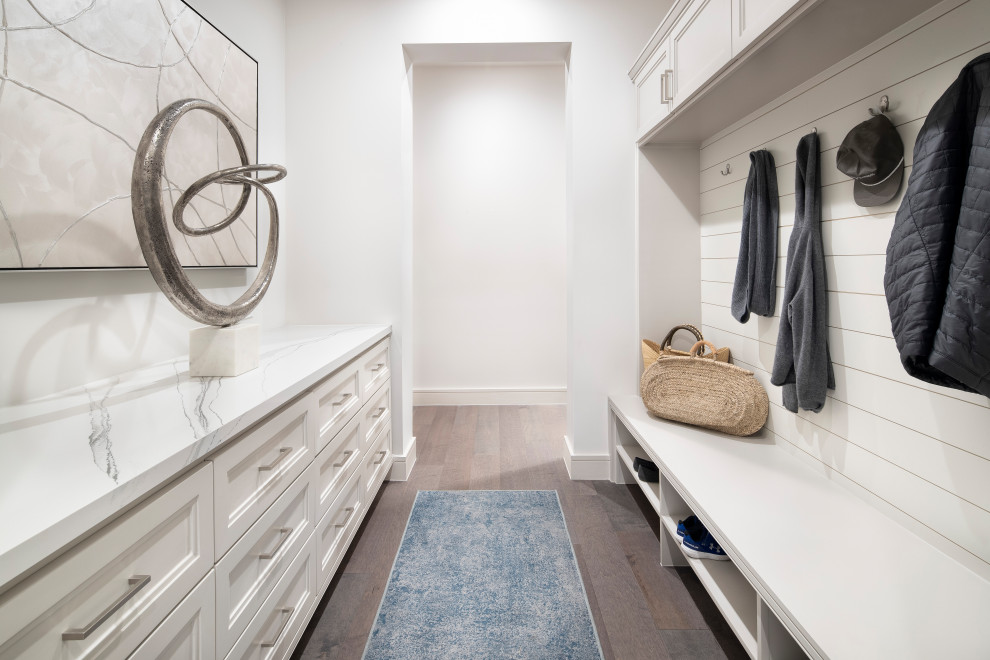 This is an example of a mid-sized country mudroom in Austin with white walls, medium hardwood floors, a single front door, a metal front door and grey floor.