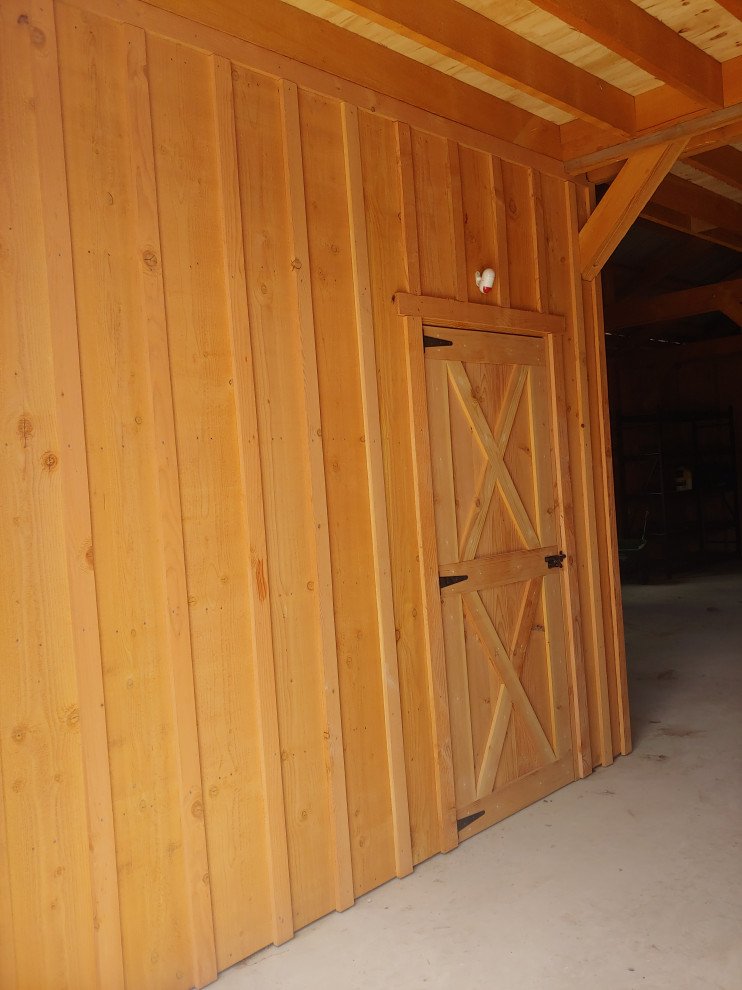 This is an example of a medium sized country detached garage workshop in Austin with four or more cars.