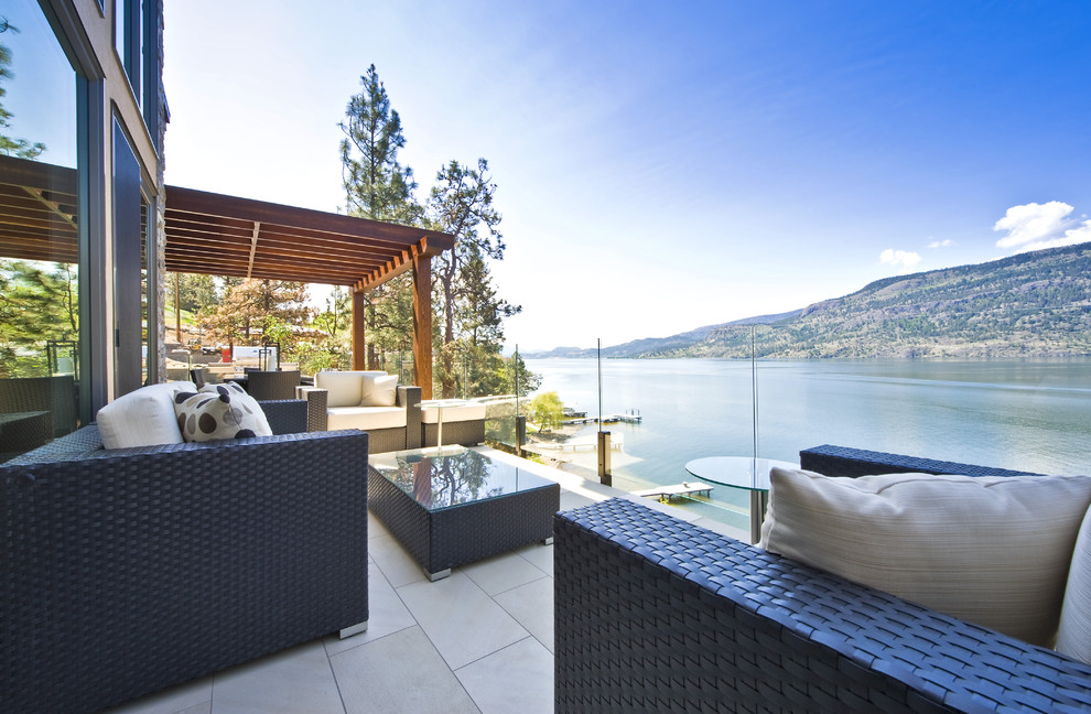 Photo of a contemporary patio in Vancouver with a pergola.