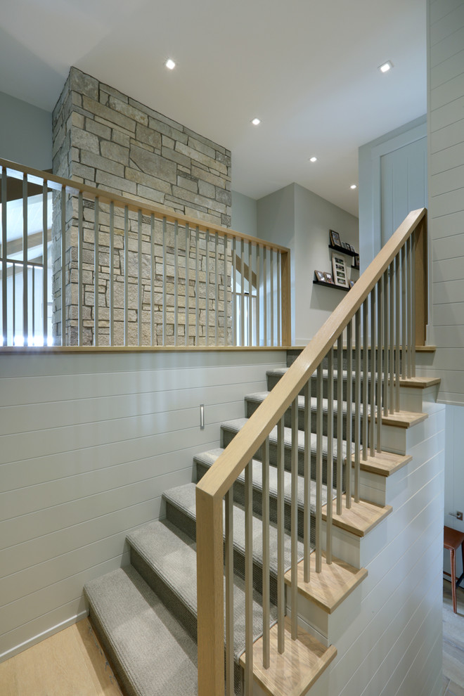 Photo of a mid-sized traditional wood u-shaped staircase in Other with wood risers and wood railing.