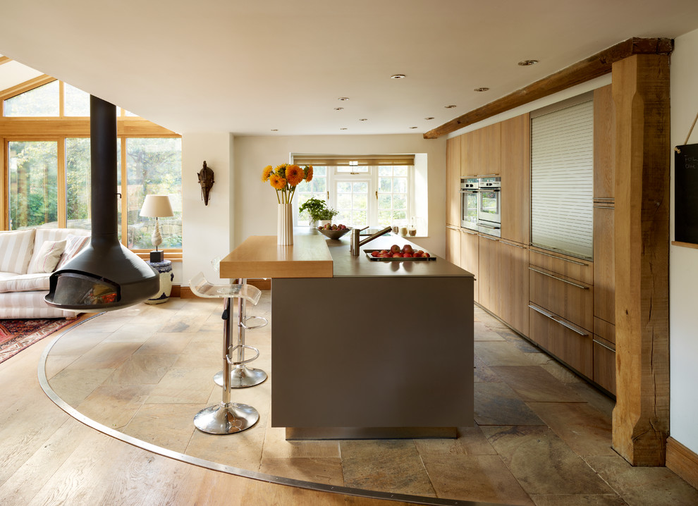 This is an example of a contemporary kitchen in Cheshire with with island.