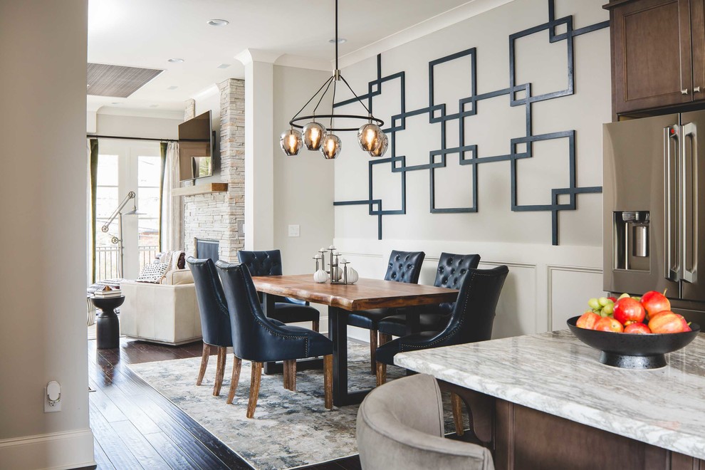 Mid-sized transitional kitchen/dining combo in Atlanta with grey walls, dark hardwood floors, a standard fireplace, a stone fireplace surround and brown floor.