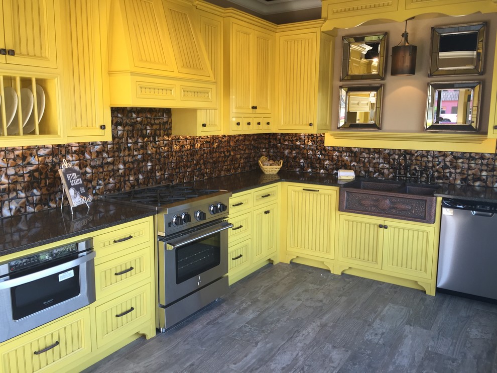 Photo of a large country l-shaped eat-in kitchen in Portland with a farmhouse sink, beaded inset cabinets, yellow cabinets, granite benchtops, brown splashback, ceramic splashback, stainless steel appliances, porcelain floors and no island.