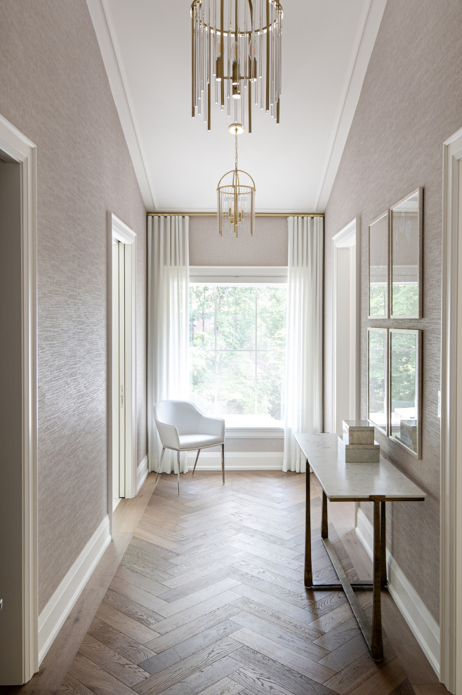 Inspiration for a mid-sized transitional light wood floor and wallpaper hallway remodel in Toronto with beige walls