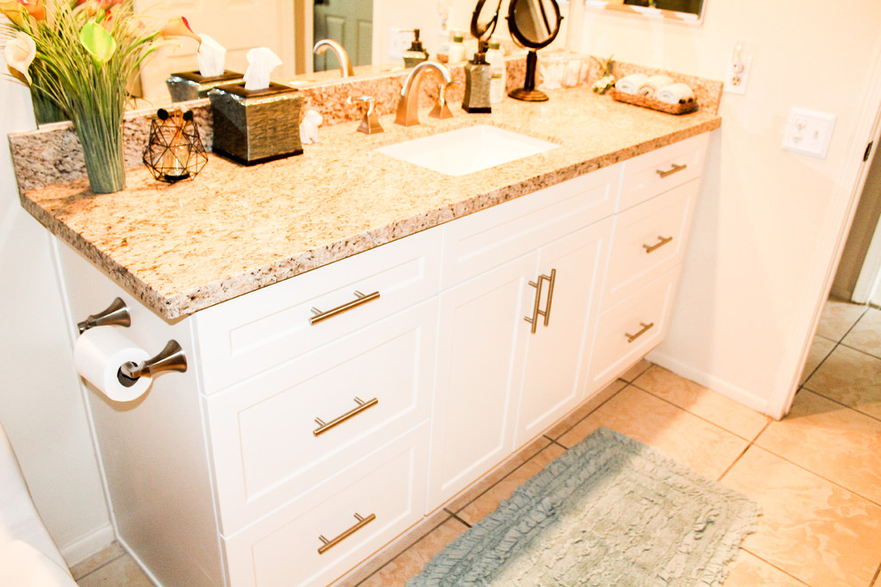Mid-sized transitional u-shaped porcelain tile and beige floor enclosed kitchen photo with an undermount sink, shaker cabinets, white cabinets, granite countertops, brown backsplash, stone slab backsplash, stainless steel appliances, no island and brown countertops