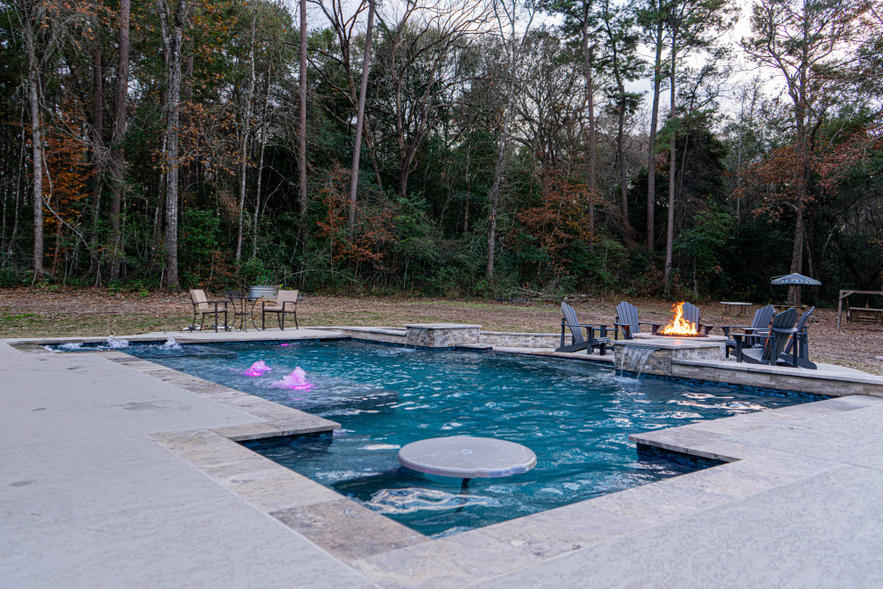 Inspiration for a large country backyard rectangular pool remodel in Houston with decking