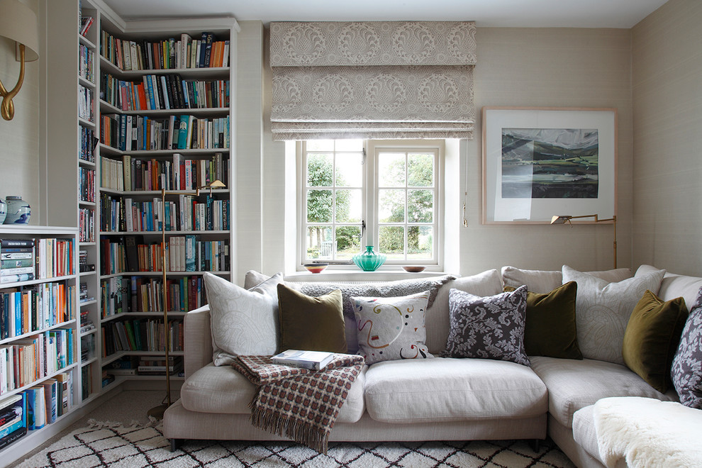Transitional enclosed living room in London with a library and beige walls.