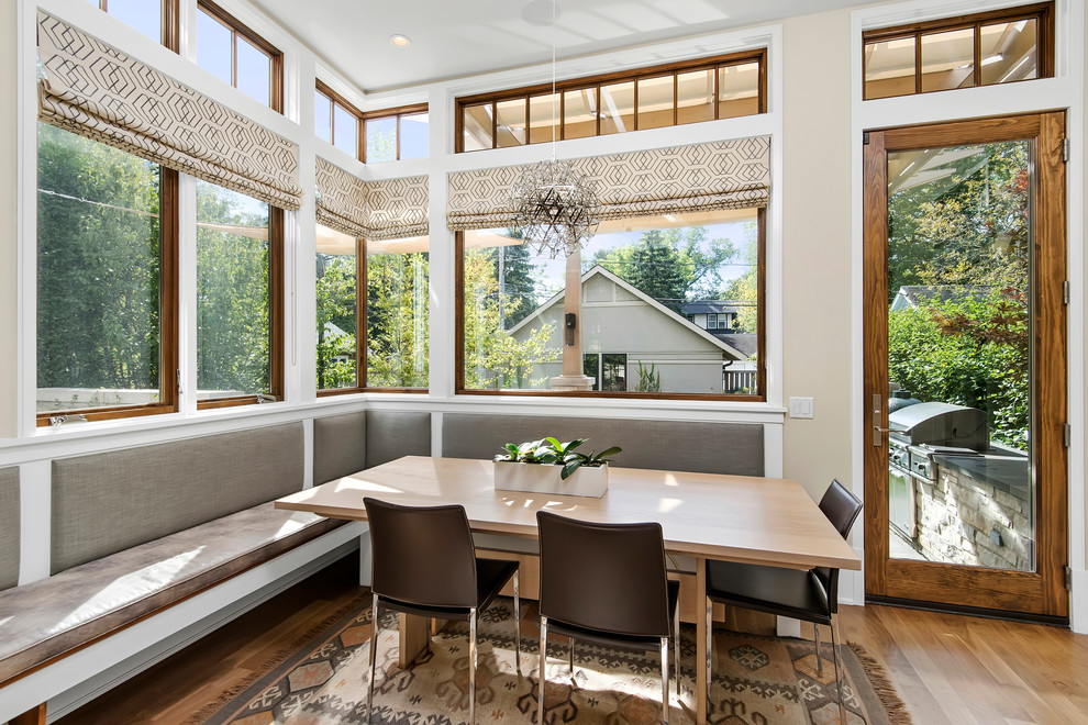 Contemporary open plan dining in Chicago with light hardwood floors.