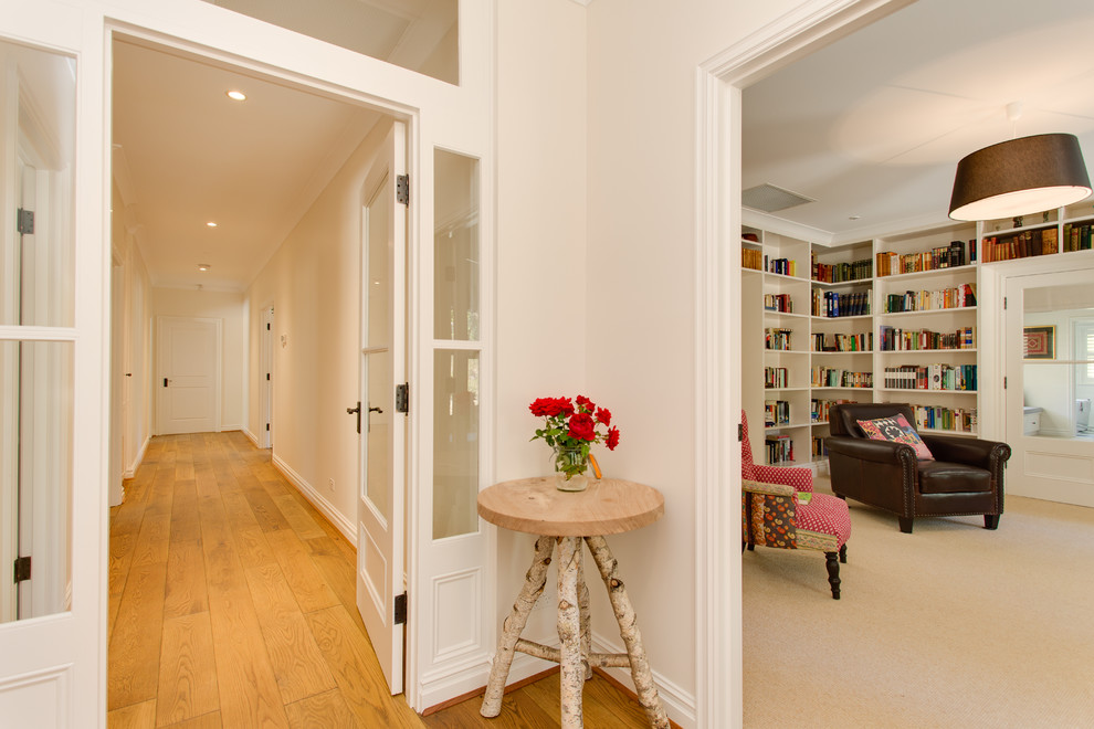 Inspiration for a mid-sized traditional hallway in Adelaide with white walls and medium hardwood floors.