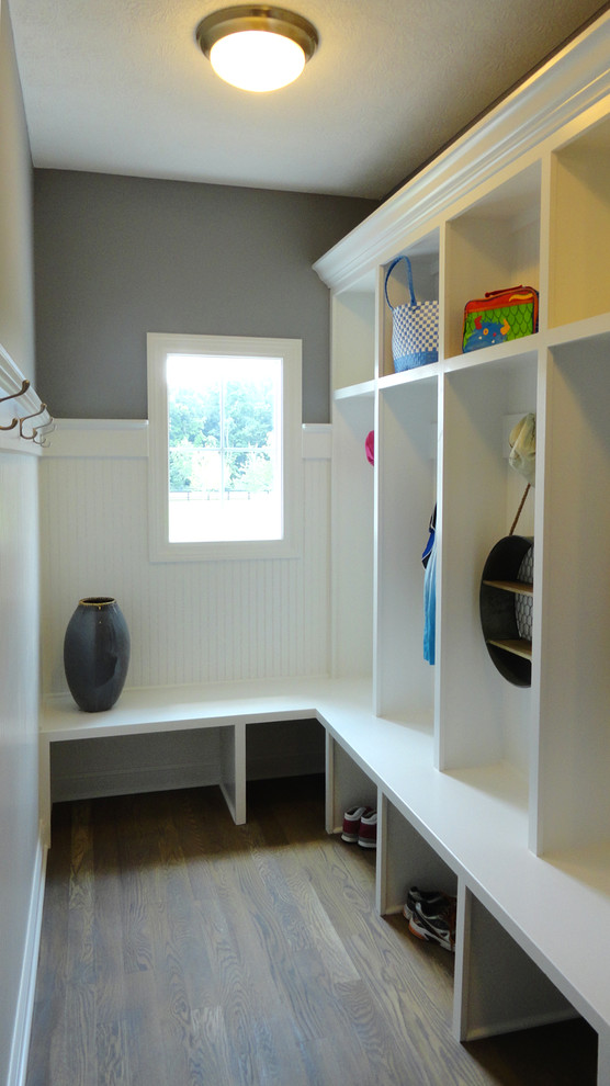 Design ideas for a large transitional mudroom in Columbus with grey walls and medium hardwood floors.