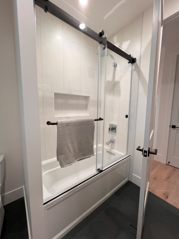 This is an example of a mid-sized country kids bathroom in San Francisco with shaker cabinets, grey cabinets, an alcove tub, a shower/bathtub combo, white tile, porcelain tile, solid surface benchtops, a sliding shower screen, white benchtops, a double vanity and a built-in vanity.