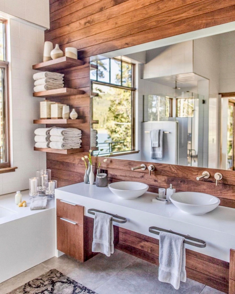 Design ideas for a country master bathroom in Denver with flat-panel cabinets, medium wood cabinets, a japanese tub, a corner shower, a vessel sink, beige floor, a hinged shower door, white benchtops, a double vanity, a floating vanity and wood walls.