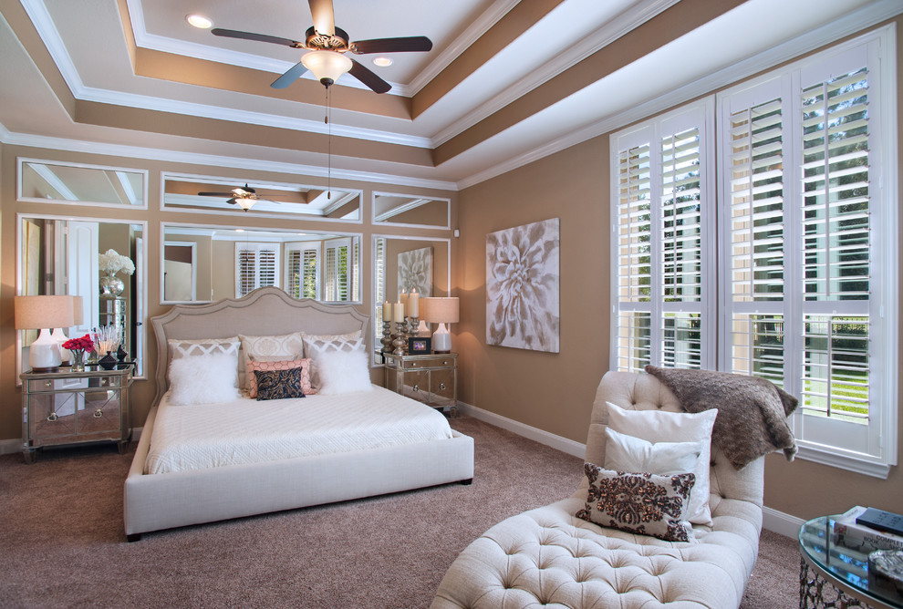 This is an example of a large traditional master bedroom in Austin with brown walls and carpet.