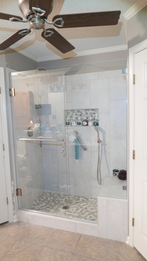 Inspiration for a mid-sized transitional master bathroom in Other with an alcove shower, beige tile, porcelain tile, porcelain floors, multi-coloured floor, a hinged shower door and a shower seat.