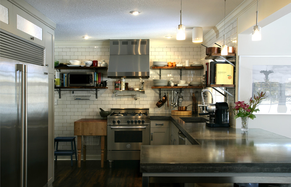 Photo of a contemporary u-shaped kitchen in Minneapolis with stainless steel appliances, open cabinets, concrete benchtops, white splashback and subway tile splashback.