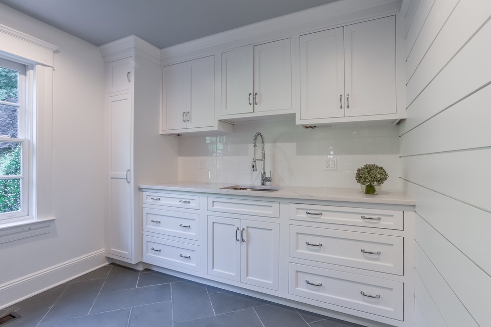 Photo of a small transitional single-wall utility room in Atlanta with an undermount sink, white cabinets, quartzite benchtops and white benchtop.