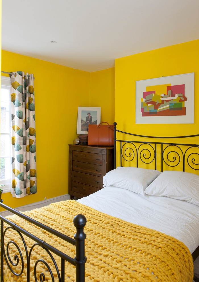 Inspiration for a small eclectic bedroom in London with yellow walls.