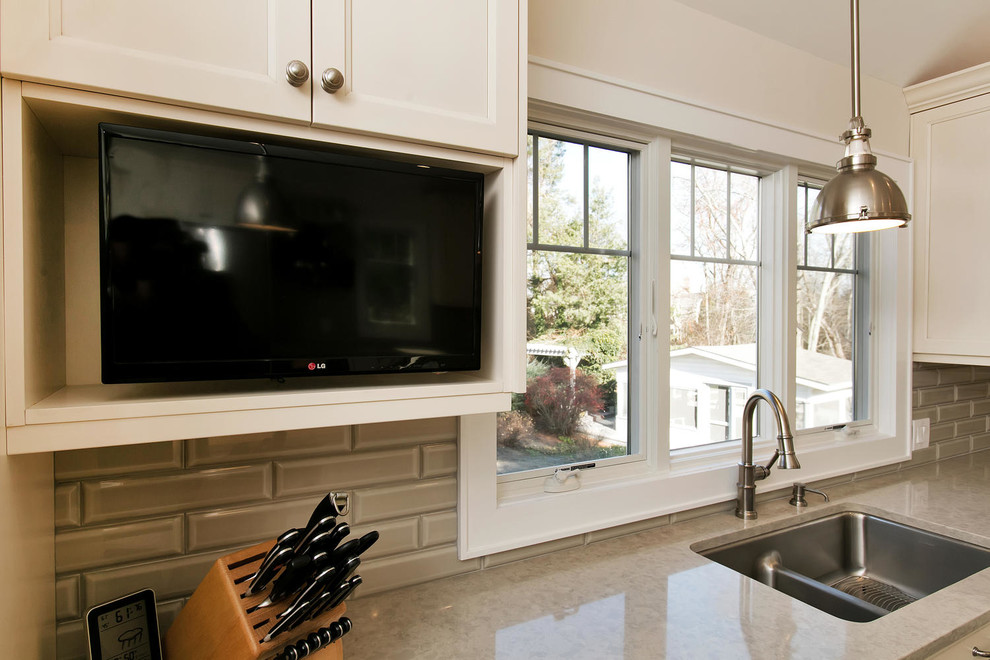 Mid-sized transitional u-shaped porcelain tile eat-in kitchen photo in New York with an undermount sink, recessed-panel cabinets, white cabinets, wood countertops, gray backsplash, subway tile backsplash, stainless steel appliances and an island