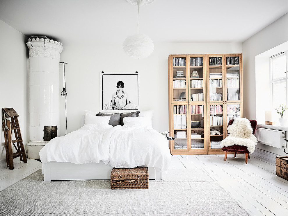 Mid-sized scandinavian master bedroom in Gothenburg with white walls, painted wood floors and no fireplace.