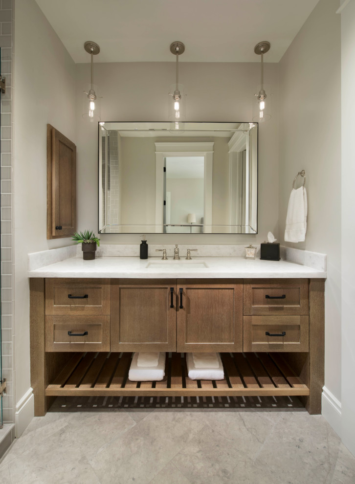 Inspiration for a mediterranean bathroom in Phoenix with recessed-panel cabinets, black cabinets, an alcove tub, an alcove shower, limestone floors, marble benchtops, grey floor, a single vanity and a built-in vanity.