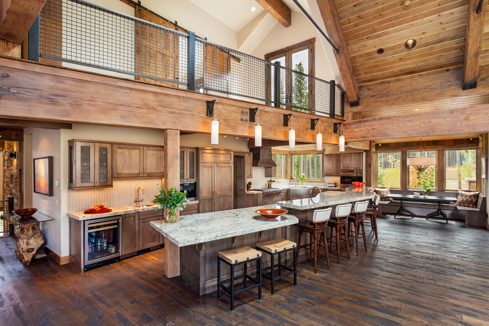Inspiration for a transitional eat-in kitchen in Denver with flat-panel cabinets, dark hardwood floors and with island.
