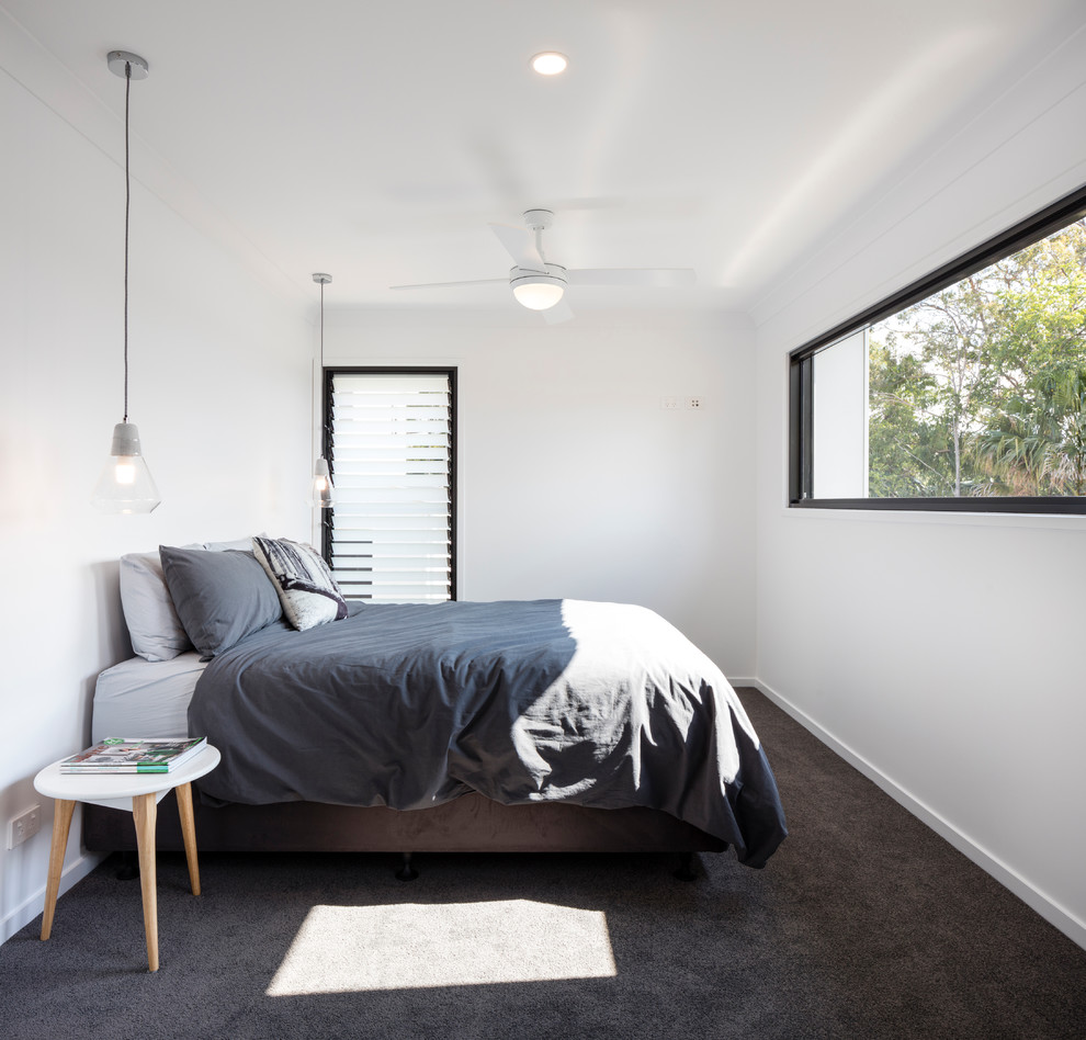 Photo of a mid-sized contemporary master bedroom in Sunshine Coast with white walls, carpet and grey floor.